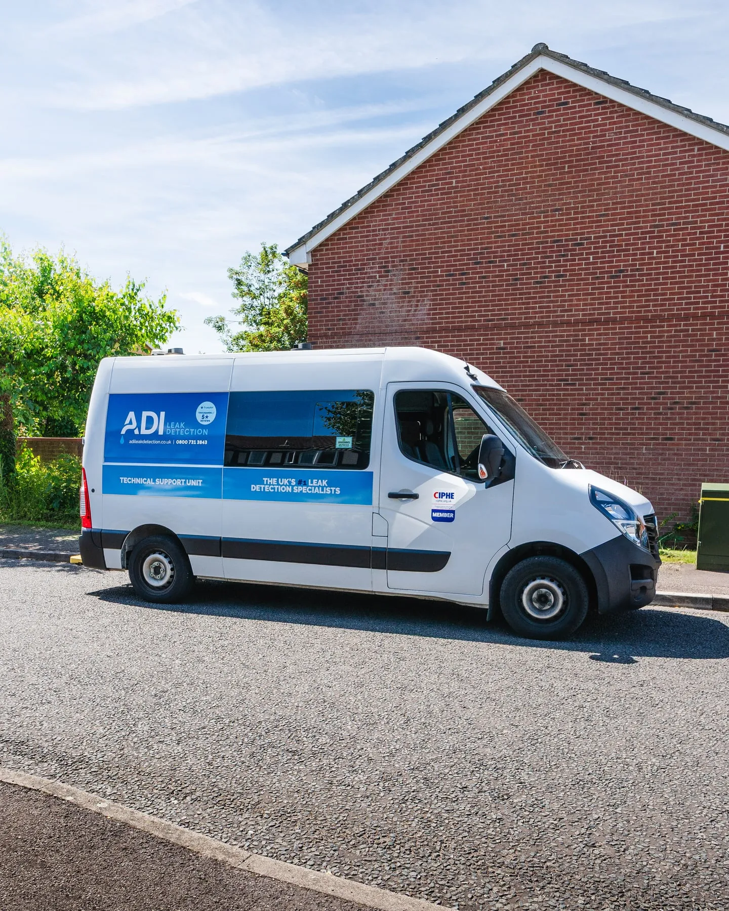 ADI Leak Detection van beside a brick home on a residential street
