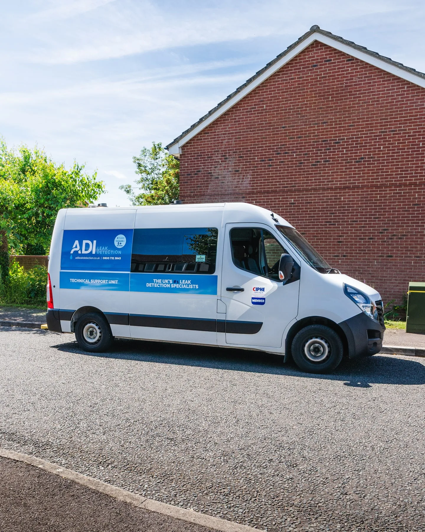 ADI Leak Detection van parked outside a red-brick residential property